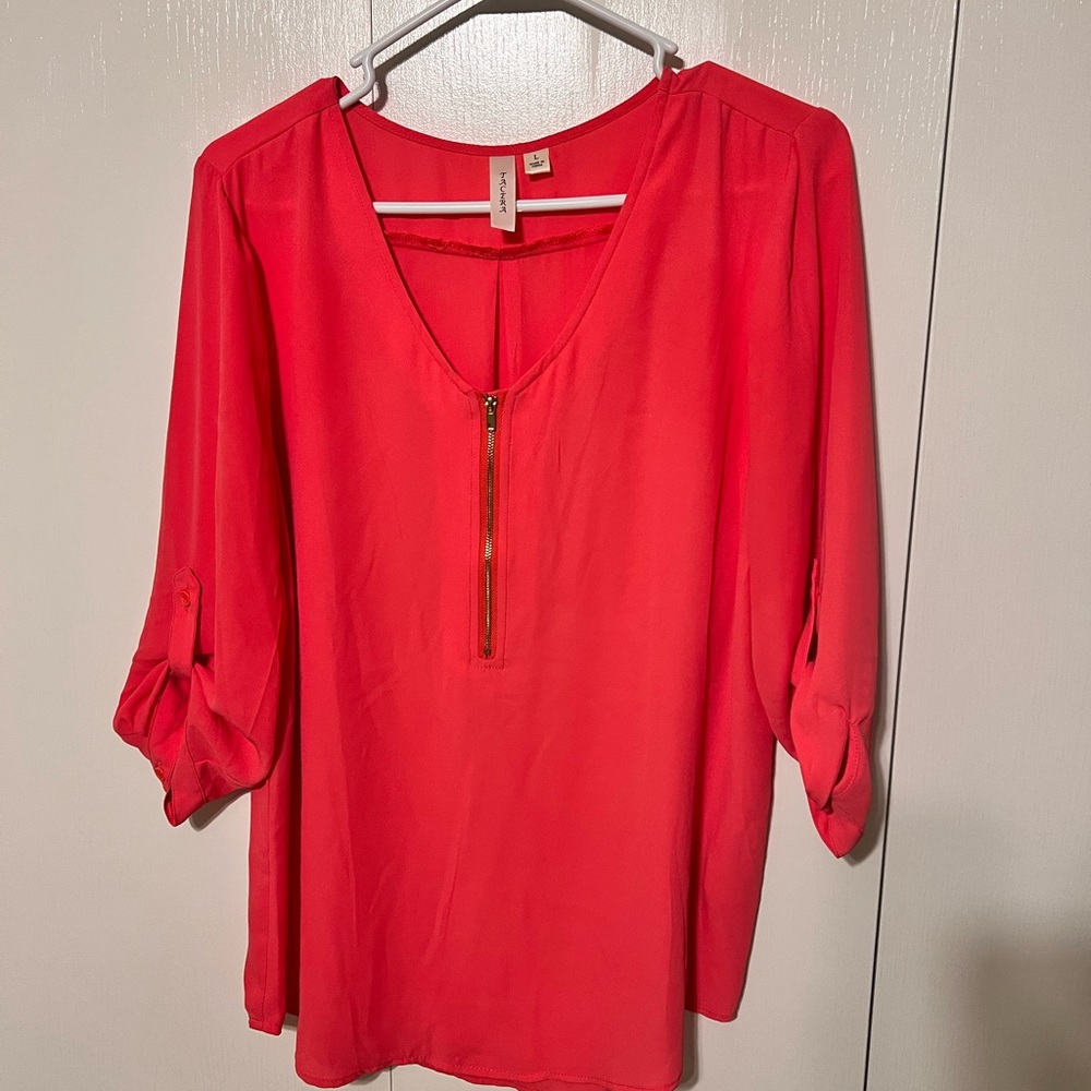 Large pink shirt with gold zipper detail.